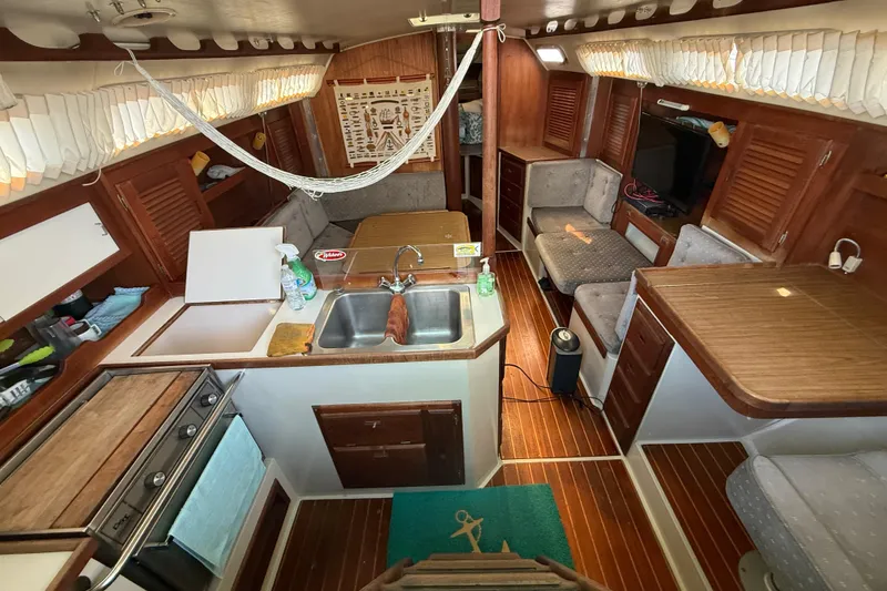 Interior of a 1987 Catalina 36 sailboat with wood finishes and cozy seating.