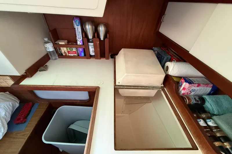 Interior of 1987 Catalina 36 sailboat kitchen with storage and supplies.