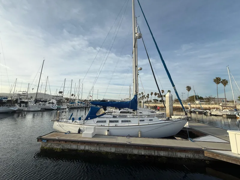 1980 Rival 32 sailboat docked in marina.