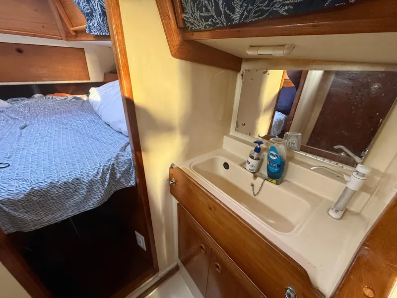 Interior of a 1980 Rival 32 yacht with sink and sleeping area.