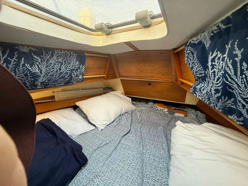 Interior of a 1980 Rival 32 yacht with cozy bedding.