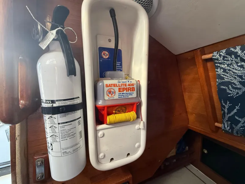 Fire extinguisher and EPIRB on Rival 32 boat, year 1980.