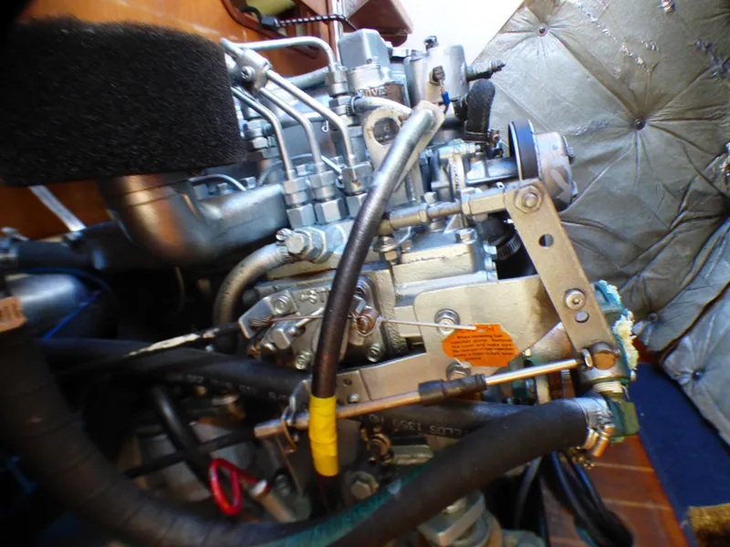 Engine compartment of a 1984 Catalina 36 Sloop, showcasing mechanical components and wiring.