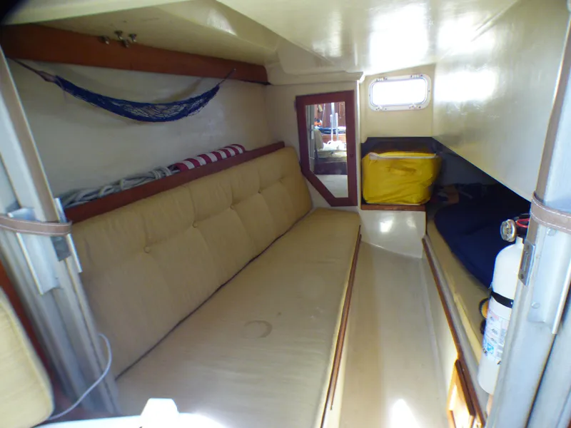 Interior of 1984 Catalina 36 Sloop with beige seating and storage space.
