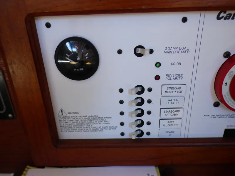 Control panel of a 1984 Catalina 36 Sloop with fuel gauge and switches.