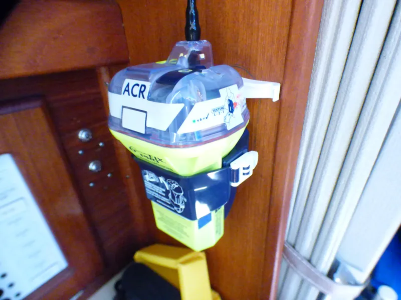 Emergency beacon mounted on 1984 Catalina 36 Sloop interior wooden panel.