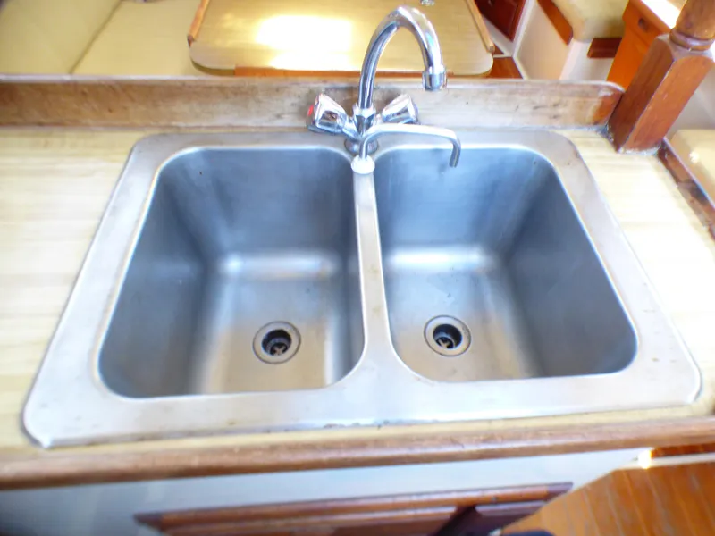 Double stainless steel sink in 1984 Catalina 36 Sloop yacht kitchen.