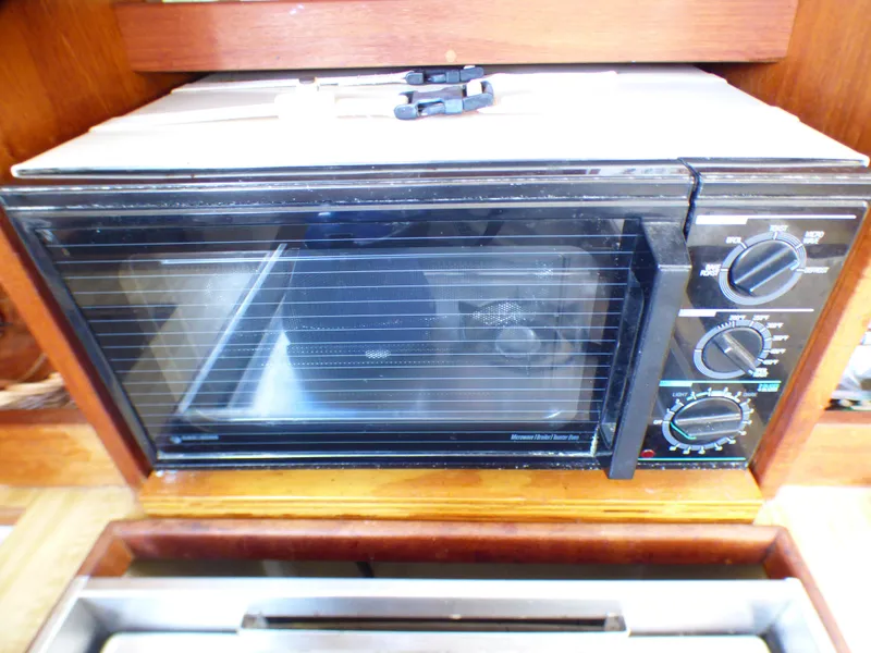 Built-in microwave oven in a 1984 Catalina 36 Sloop yacht kitchen.