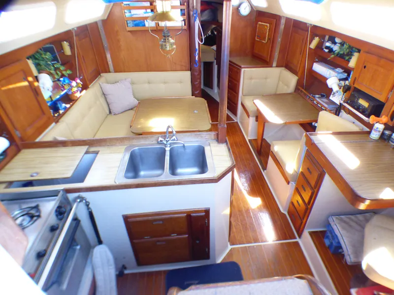 Interior of 1984 Catalina 36 Sloop with wood finish, kitchen, and seating area.