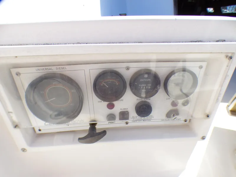 Control panel of a 1984 Catalina 36 Sloop sailboat with gauges and switches.