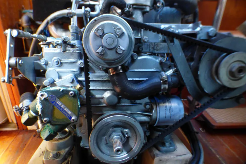 Engine of a 1984 Catalina 36 Sloop sailboat, showcasing mechanical components and belts.