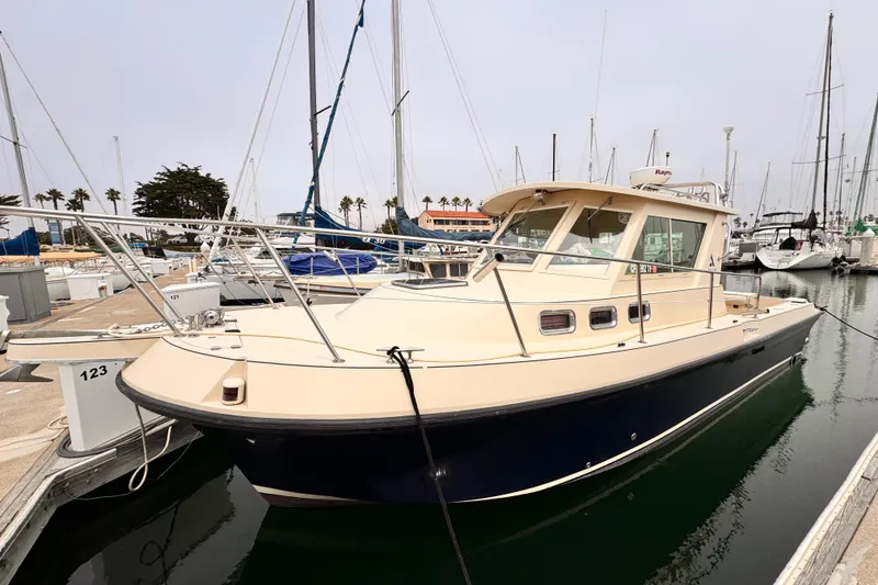 2003 Albin 28 TE boat docked in marina, surrounded by sailboats.