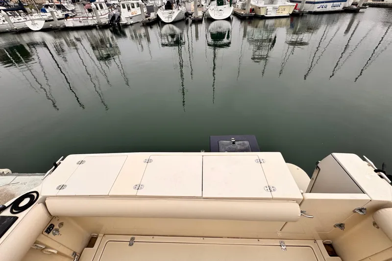 2003 Albin 28 TE boat stern view at marina with docked boats.