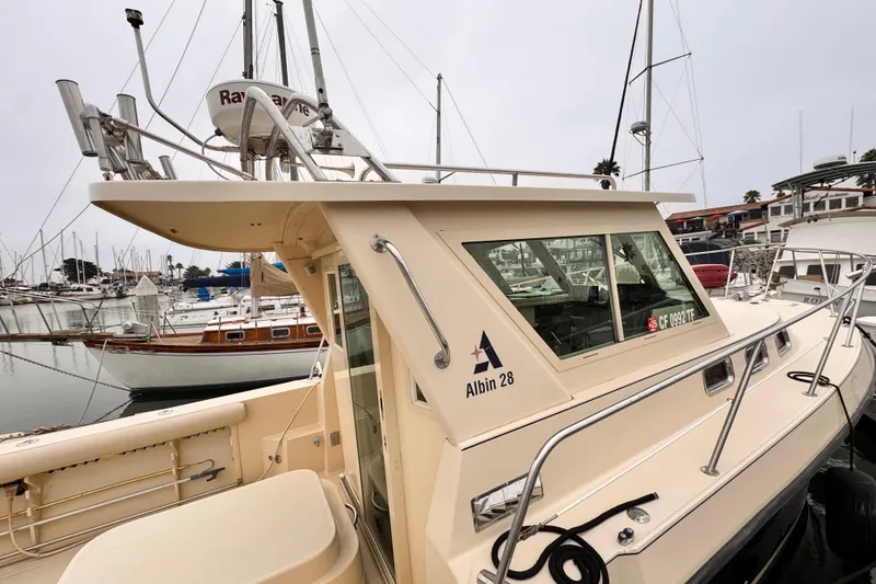2003 Albin 28 TE boat docked in a marina, showcasing its sleek design and structure.