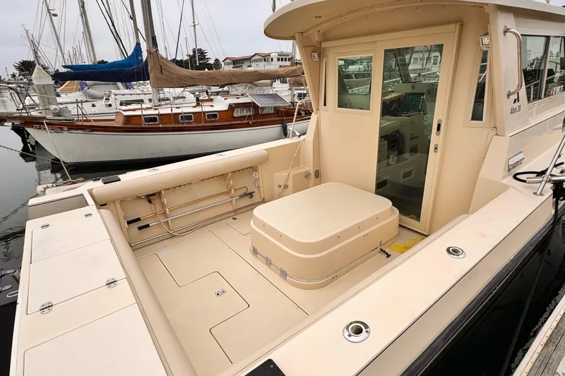 2003 Albin 28 TE boat with spacious deck and sliding cabin door, docked at marina.