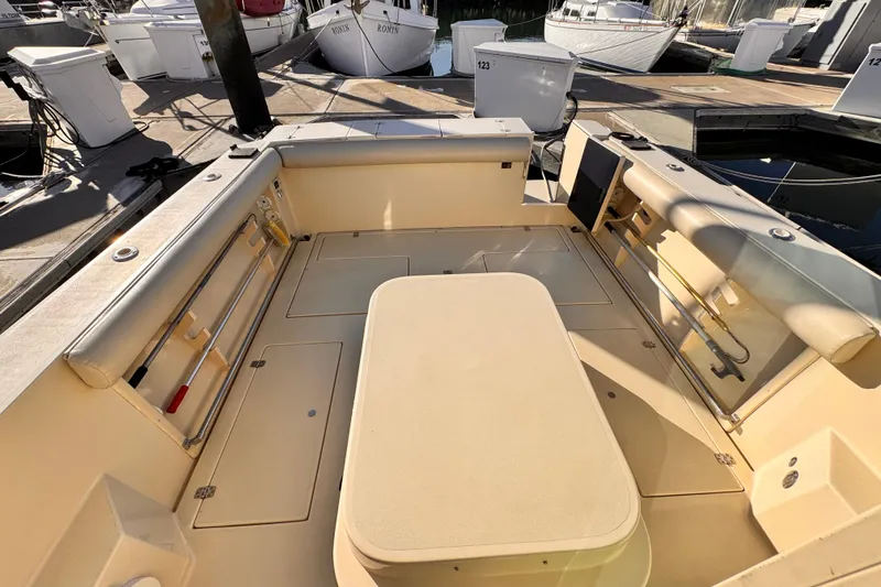 2003 Albin 28 TE boat interior with seating and storage at a marina.