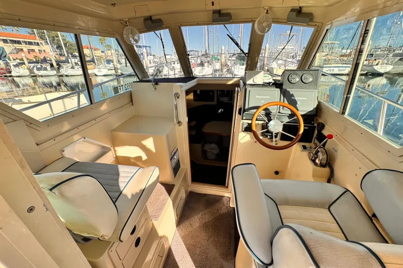 Interior of a 2003 Albin 28 TE boat with steering wheel and seating.