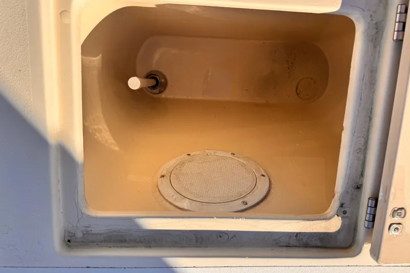 Storage compartment in a 2003 Albin 28 TE boat, featuring a circular vent.