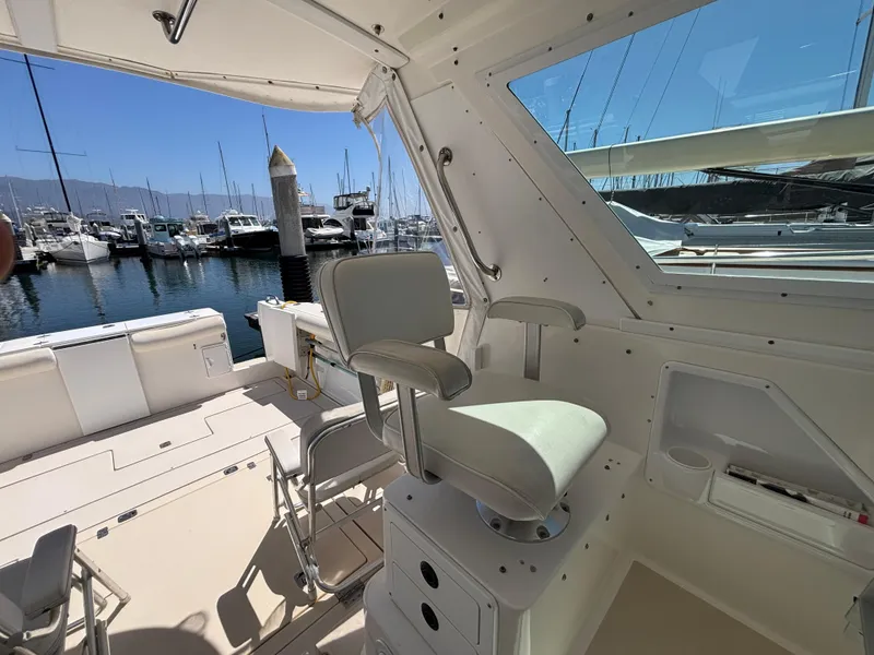 Interior view of 2004 Albin 28 TE boat, featuring seating and marina backdrop.