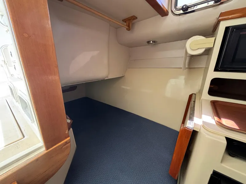 Interior cabin of 2004 Albin 28 TE boat, featuring wood accents and compact design.