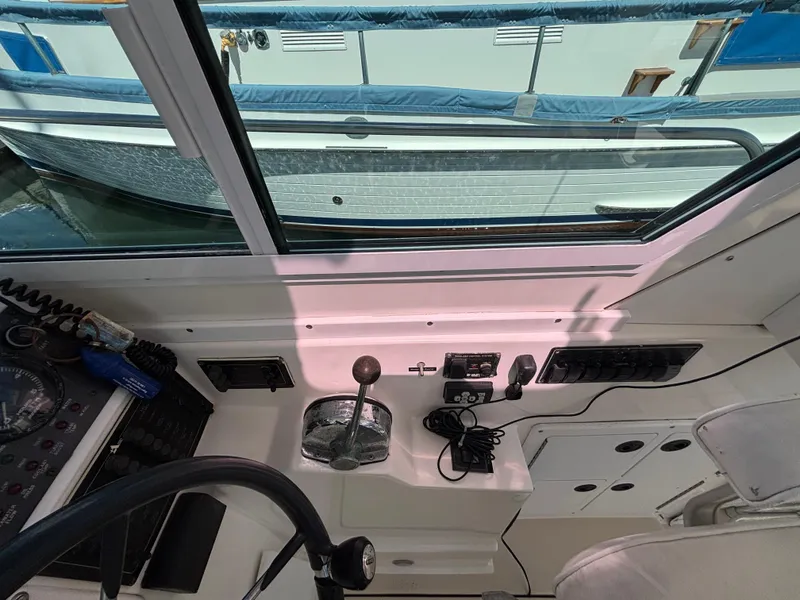 Interior view of 2004 Albin 28 TE boat cockpit with controls and steering wheel.