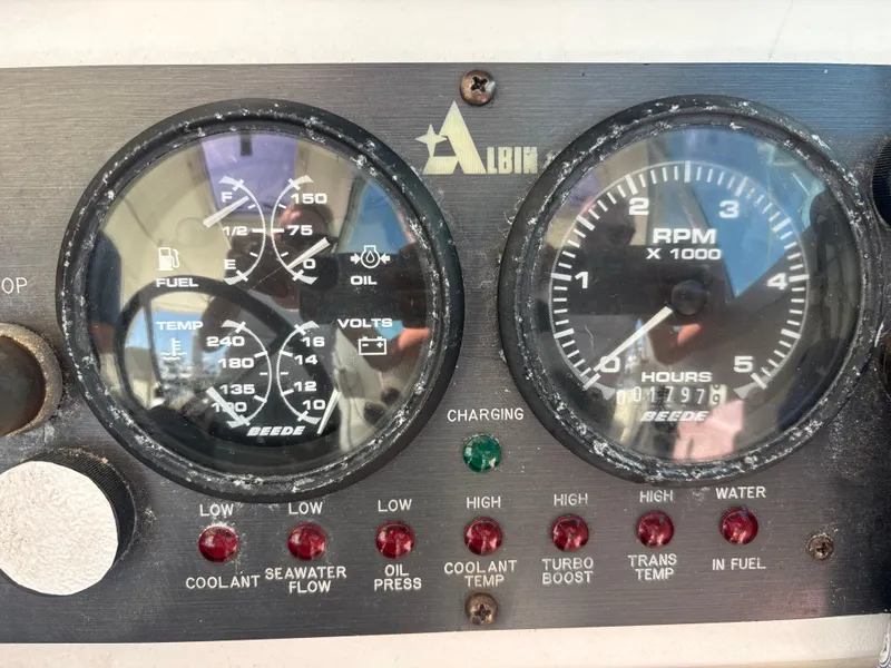 Dashboard of a 2004 Albin 28 TE boat showing fuel, RPM, and temperature gauges.