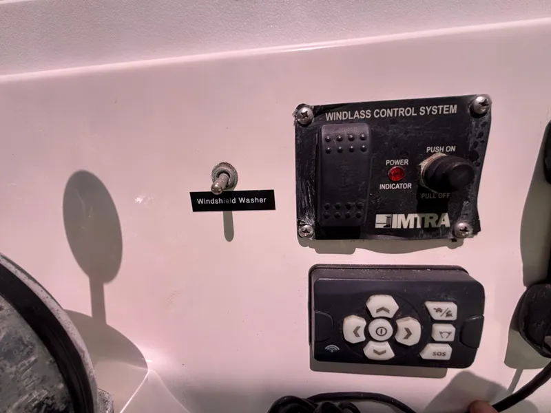 Control panel of a 2004 Albin 28 TE boat with windlass system and windshield washer switch.