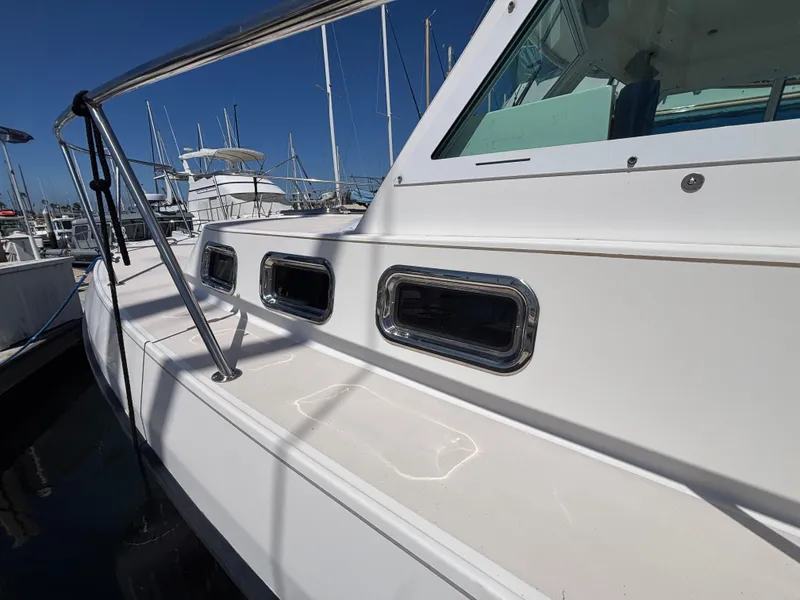 2004 Albin 28 TE boat docked, showcasing sleek white exterior and windows.