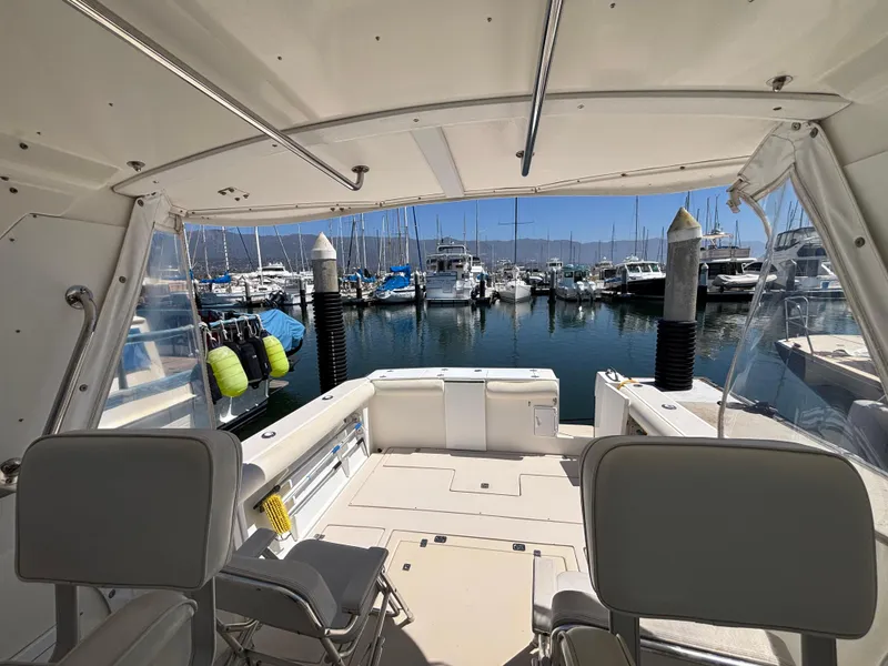 2004 Albin 28 TE boat interior view at marina, showcasing seating and docked boats.
