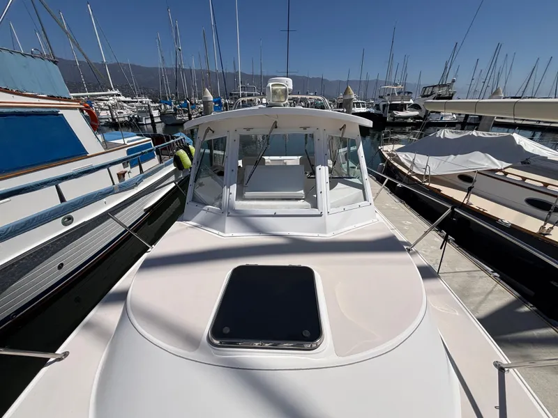 2004 Albin 28 TE boat docked in a marina, surrounded by other vessels.