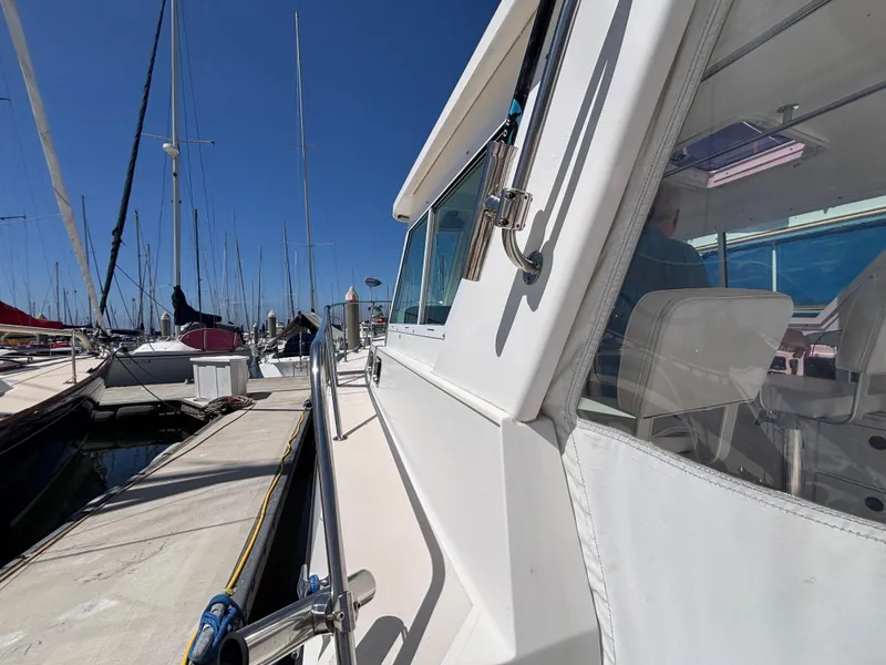 2004 Albin 28 TE boat docked at marina under clear blue sky.