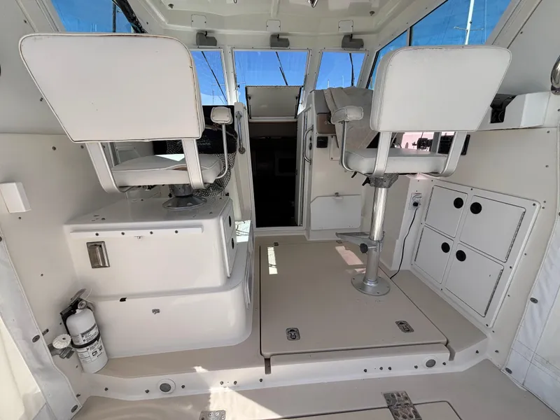 Interior of a 2004 Albin 28 TE boat with white seating and storage compartments.