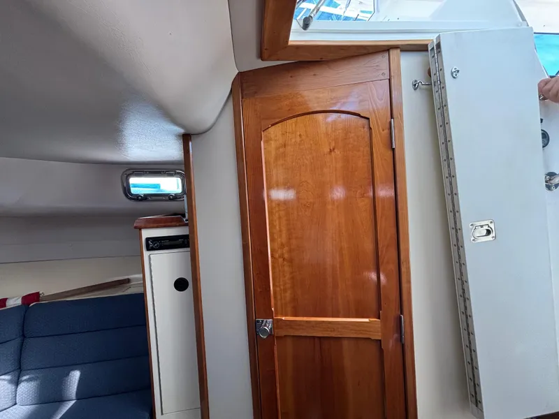 Interior of 2004 Albin 28 TE boat with wooden door and seating area.