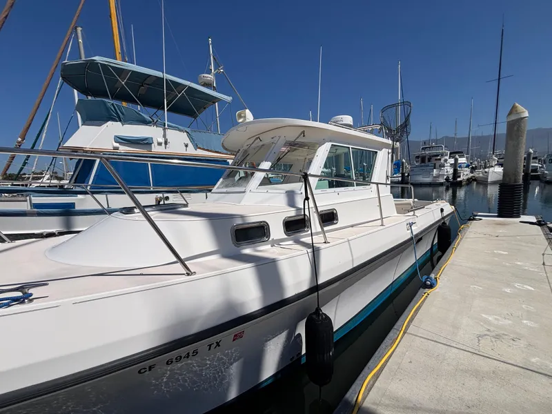 2004 Albin 28 TE boat docked at marina under clear blue sky.