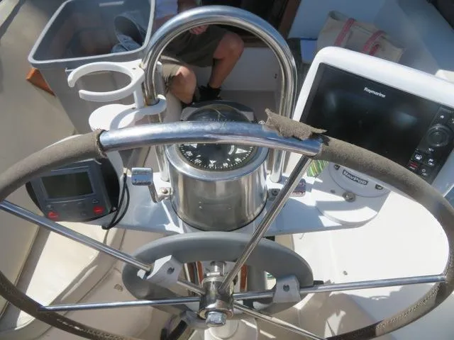 Steering wheel and navigation instruments on a 1986 Catalina 34 sailboat.