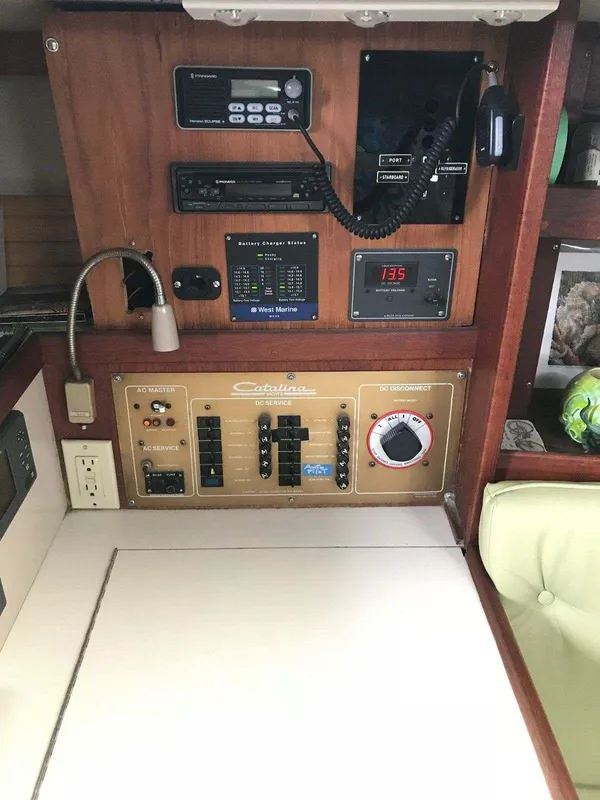 Control panel of a 1986 Catalina 34 sailboat with navigation and communication equipment.