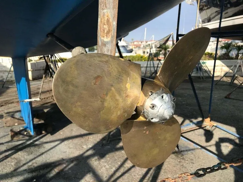 Propeller of 1986 Catalina 34 sailboat on dry dock, showcasing bronze blades.