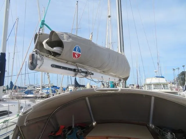1986 Catalina 34 sailboat with covered mainsail in marina setting.