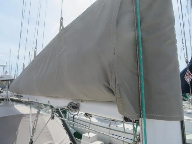 1986 Catalina 34 sailboat with covered mainsail at dock.