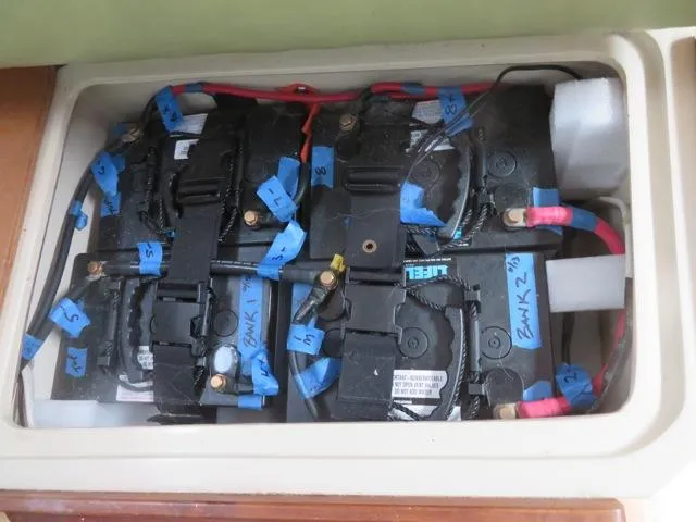 Battery compartment of a 1986 Catalina 34 sailboat with labeled connections.