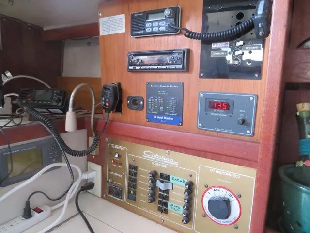 Control panel of a 1986 Catalina 34 sailboat with navigation and communication equipment.