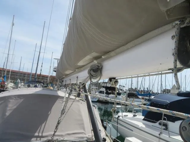 1986 Catalina 34 sailboat docked in marina, showing mast and rigging details.