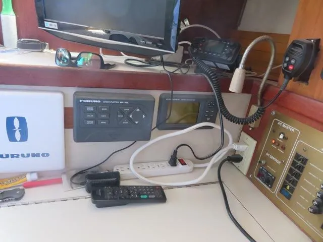 Navigation equipment and controls inside a 1986 Catalina 34 sailboat cabin.