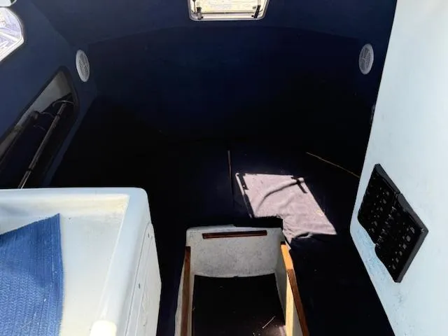 Interior of 2007 Radon Signature 26 boat, featuring dark cabin and control panel.