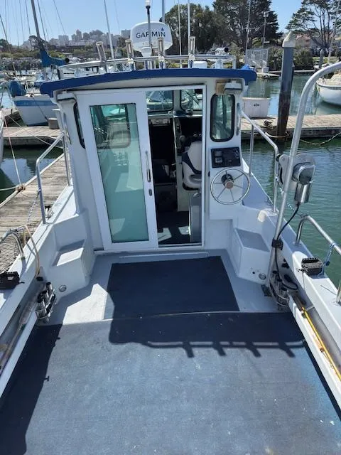 2007 Radon Signature 26 boat docked at marina, featuring spacious deck and cabin.