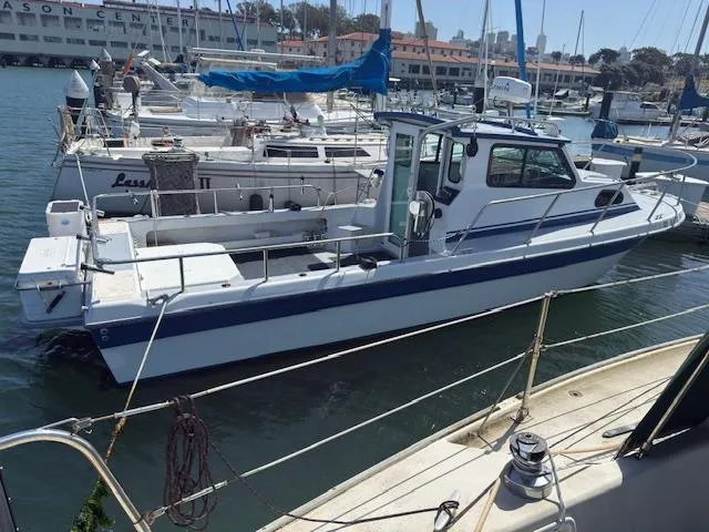 2007 Radon Signature 26 boat docked in a marina, surrounded by other vessels.