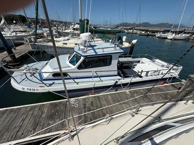 2007 Radon Signature 26 boat docked at a marina, surrounded by other vessels.
