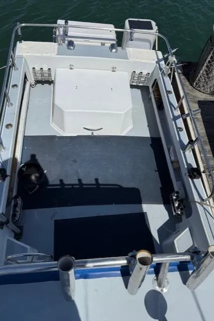 2007 Radon Signature 26 boat deck with railing and storage compartments.