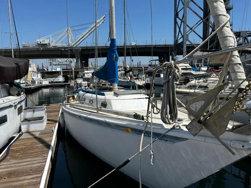 1978 Ericson 35 Sloop docked at a marina with a bridge in the background.