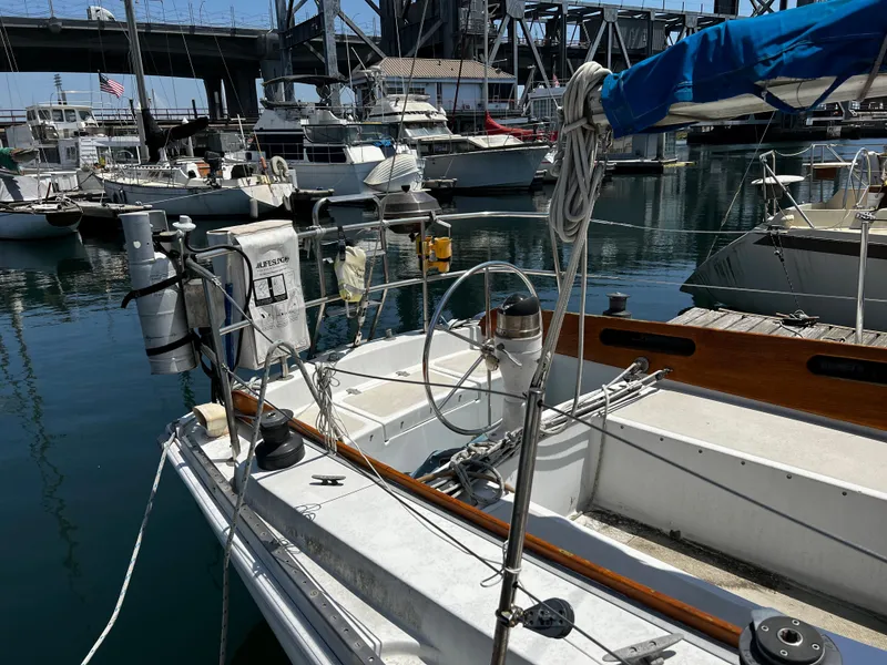1978 Ericson 35 Sloop docked in a marina with other boats.